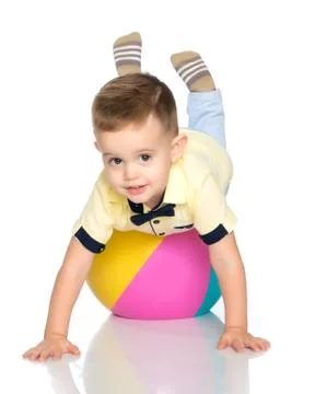 A little boy is playing with a ball. Stock Photos