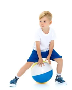 A little boy is playing with a ball. Stock Photos