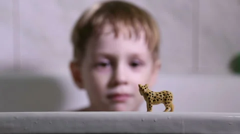 Little boy playing in the bathroom, he cleans the teeth the toy Stock Footage 60348286