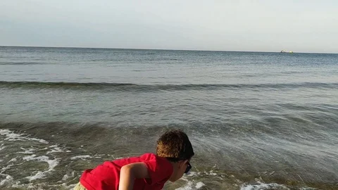 Little boy playing on the beach Stock Footage 112753913