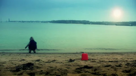 Little boy playing on the beach at sunset Video stock 35311433