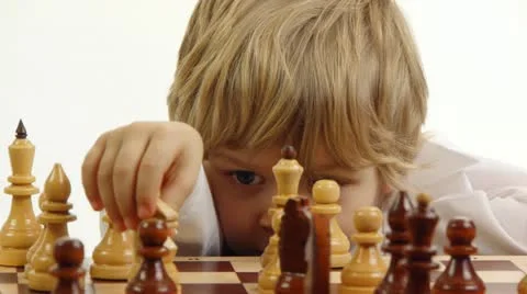 Little boy playing chess Stock Footage 21981987