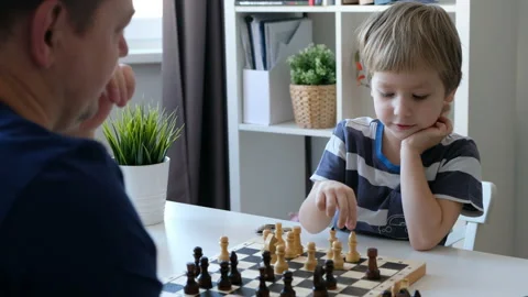 Little boy playing chess with his father. Education and family concept Stockbeeldmateriaal 104175451