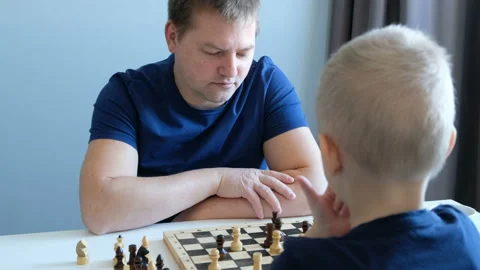 Little boy playing chess with his father. Education and family concept Stock Footage 104177997
