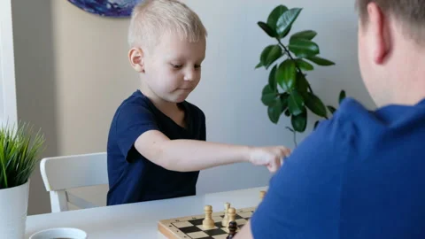 Little boy playing chess with his father. Education and family concept 動画素材 104178743