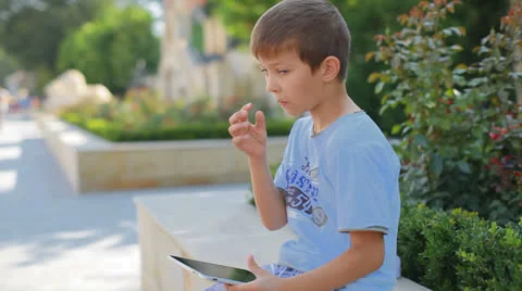 Little boy playing a computer game on the tablet Stock Footage 25303134
