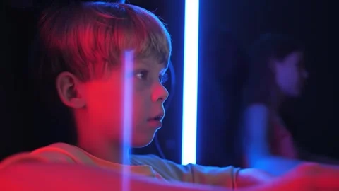 A little boy is playing computer games in a computer club in the dark. 스톡 동영상 331147104