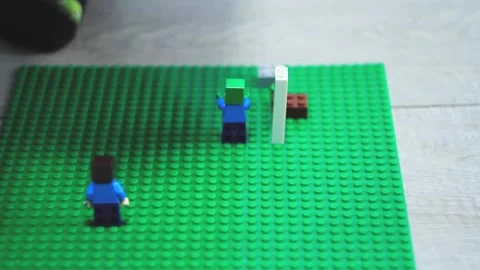 Little boy playing construction set. Minifigures made of cubes. Construction of Stock Footage 220620513
