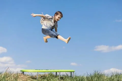 Little boy playing on the field at the day time. Stock Photos