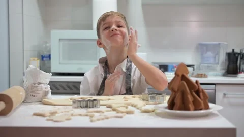 Little boy playing with flour while making christmas cookies Stock Footage 324558569
