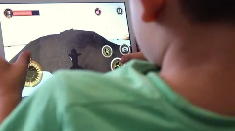 Little boy playing game on tablet Stock Footage 65300890
