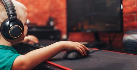 Little boy playing games on computer Stock Photos