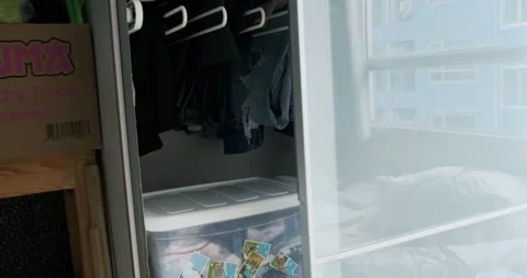 Little boy playing hidden in wardrobe cloth smile and laugh Stock Footage 141295893