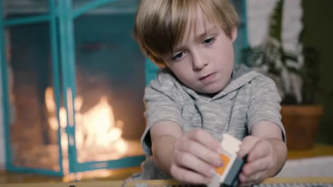 Little Boy Playing Inside with Lego Building Block Toys (6K) Stock Footage 230284931