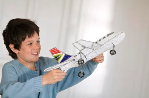 Little boy playing with model aeroplane Stock Photos