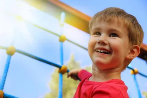 Little boy playing on monkey bars Photos