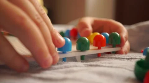Little boy playing with multicolor kid mosaic pins Stock Footage 62367579