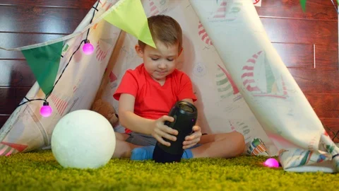 Little boy is playing with music column Stock Footage 87838651
