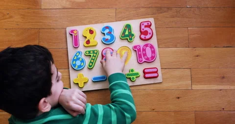 A little boy  playing on numeric board on the floor. Stock Footage 184490304