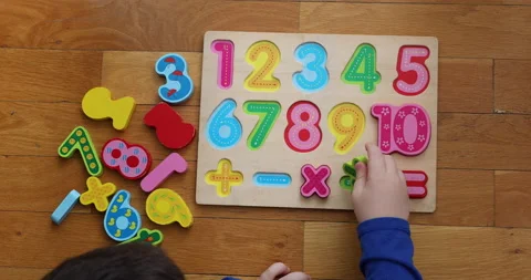 A little boy  playing on numeric board on the floor. Stock Footage 184495787