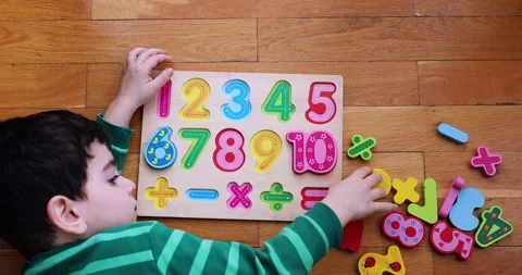 A little boy  playing on numeric board on the floor. Stock Footage 184511998