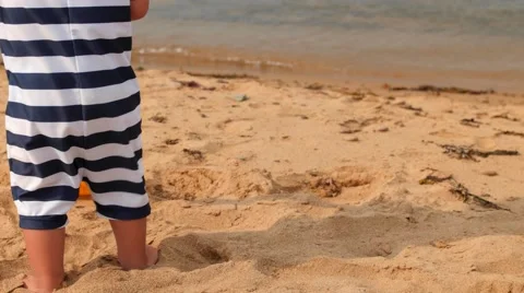 Little boy playing on ocean beach in sand Stock Footage 67168224