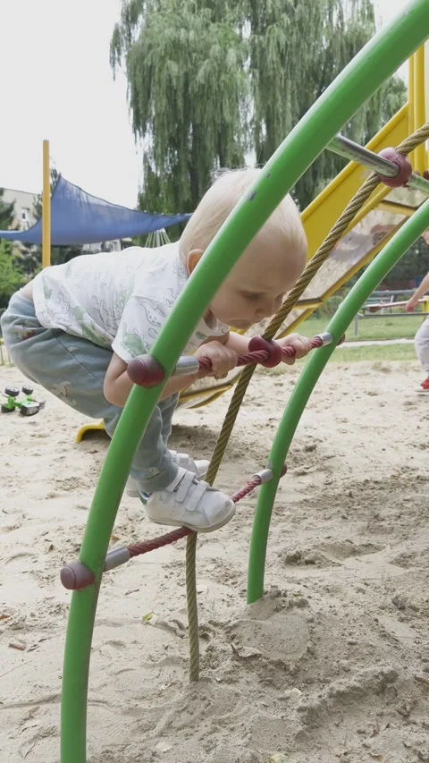 A little boy is playing on the playground. Stock Footage 312942760