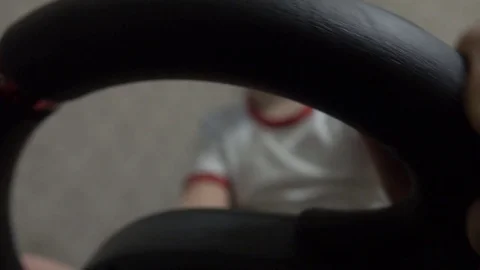 Little boy playing racing computer game using steering wheel 動画素材 73285641