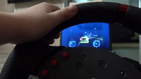 Little boy playing racing computer game using steering wheel. Beginner concept Stock Footage 73441053