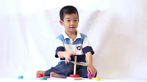 Little boy playing rainbow tower made of montessori educational materials Stock Footage 47219957