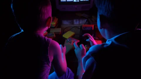 Little boy playing retro console with his friend, having fun Stock Footage 126204654