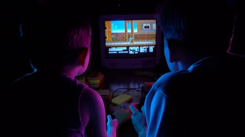 Little boy playing retro console with his friend, having fun Stock Footage 126204655