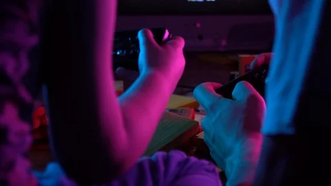 Little boy playing retro console with his friend, having fun, neon lighting Stock Footage 126204760