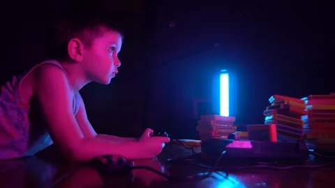 Little boy playing in retro console, side view. Neon lighting Stock Footage 126204761