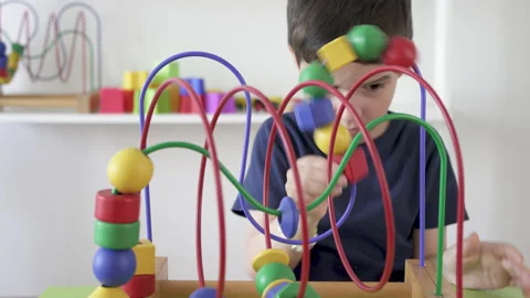 Little boy playing with roller coaster maze toy skill Stock-Footage 212606857