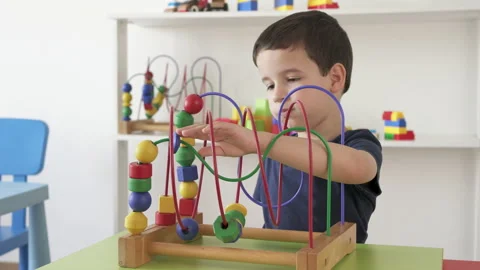 Little boy playing with roller coaster maze toy Vidéo 212607068