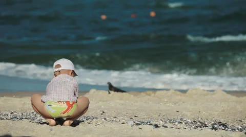 Little boy playing in the sand on the beach Stock Footage 24124650