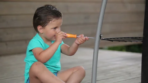 Little boy playing with a screwdriver Stock Footage 90473683