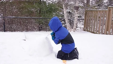 A little boy is playing with snow Stock Footage 230916396
