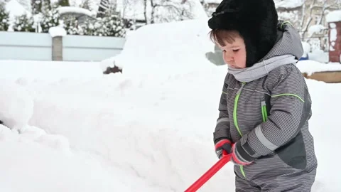 Little boy playing with snow in winter. Baby boy in warm overalls. Stock Footage 171110907