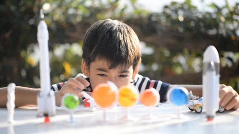 Little boy playing space ship and planet galaxy toy  Stockbeeldmateriaal 105148771