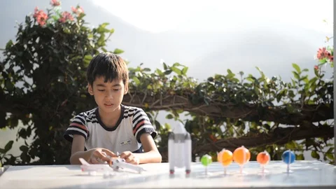 Little boy playing space ship and planet galaxy toy  Stockbeeldmateriaal 105148881