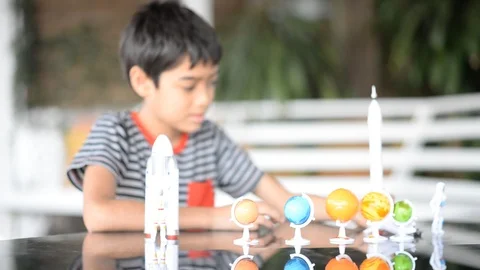 Little boy playing space ship and planet galaxy toy  Stockbeeldmateriaal 105148918