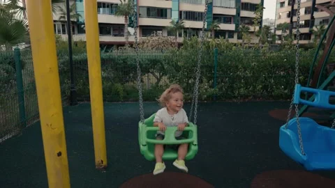 Little boy playing on swing in backyard at coutryside. Happy Boy on Swing. Slow Vídeos de archivo 217435086