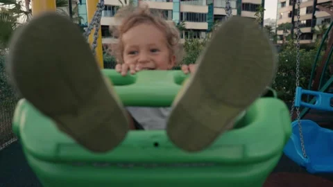 Little boy playing on swing in backyard at coutryside. Happy Boy on Swing. Slow Stock Footage 218020435