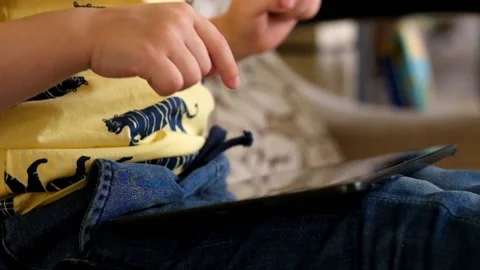 Little boy Playing with Tablet, close up Stock Footage 89464532