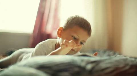 Little boy playing on the tablet computer games Stock Footage 30654090