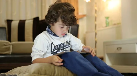 Little boy playing on the tablet computer games Stock Footage 44393607