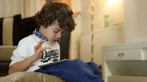 Little boy playing on the tablet computer games Stock Footage 44394206