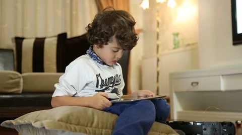 Little boy playing on the tablet computer games Stock Footage 44394281